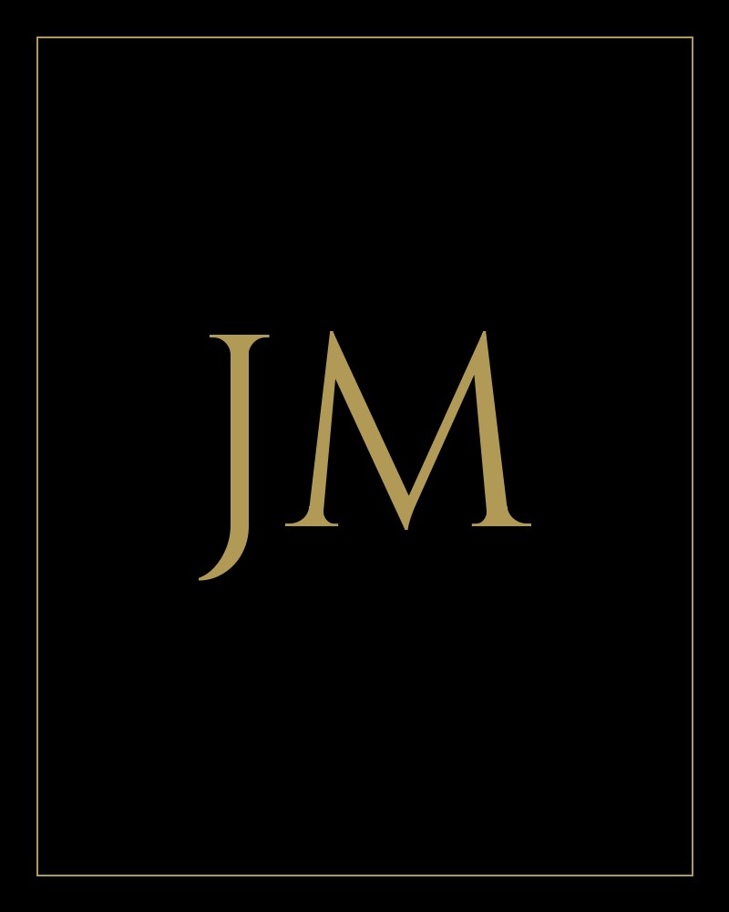 Gold monogram of the initials JM for Jenna Mateo of The Tackett Team