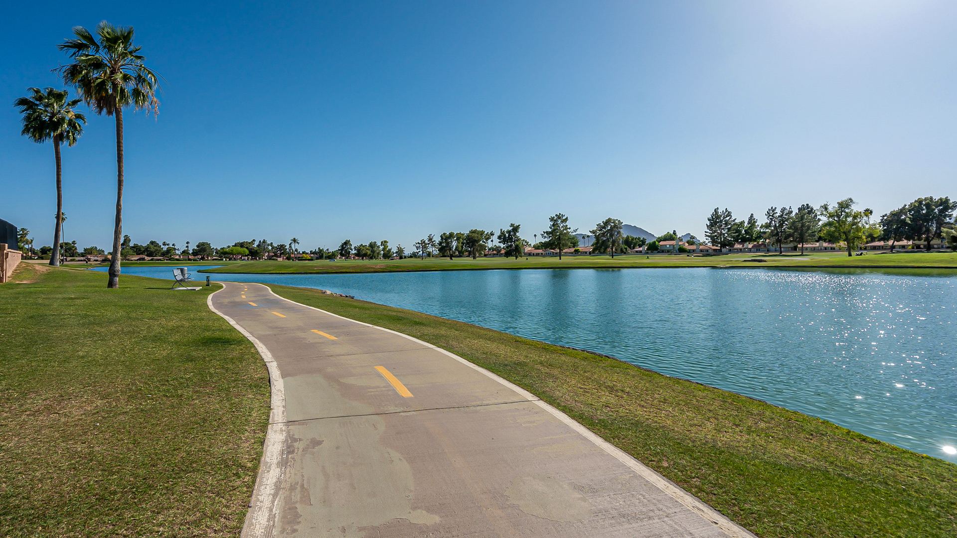 Palm-lined walking path along a lake in McCormick Ranch, Scottsdale