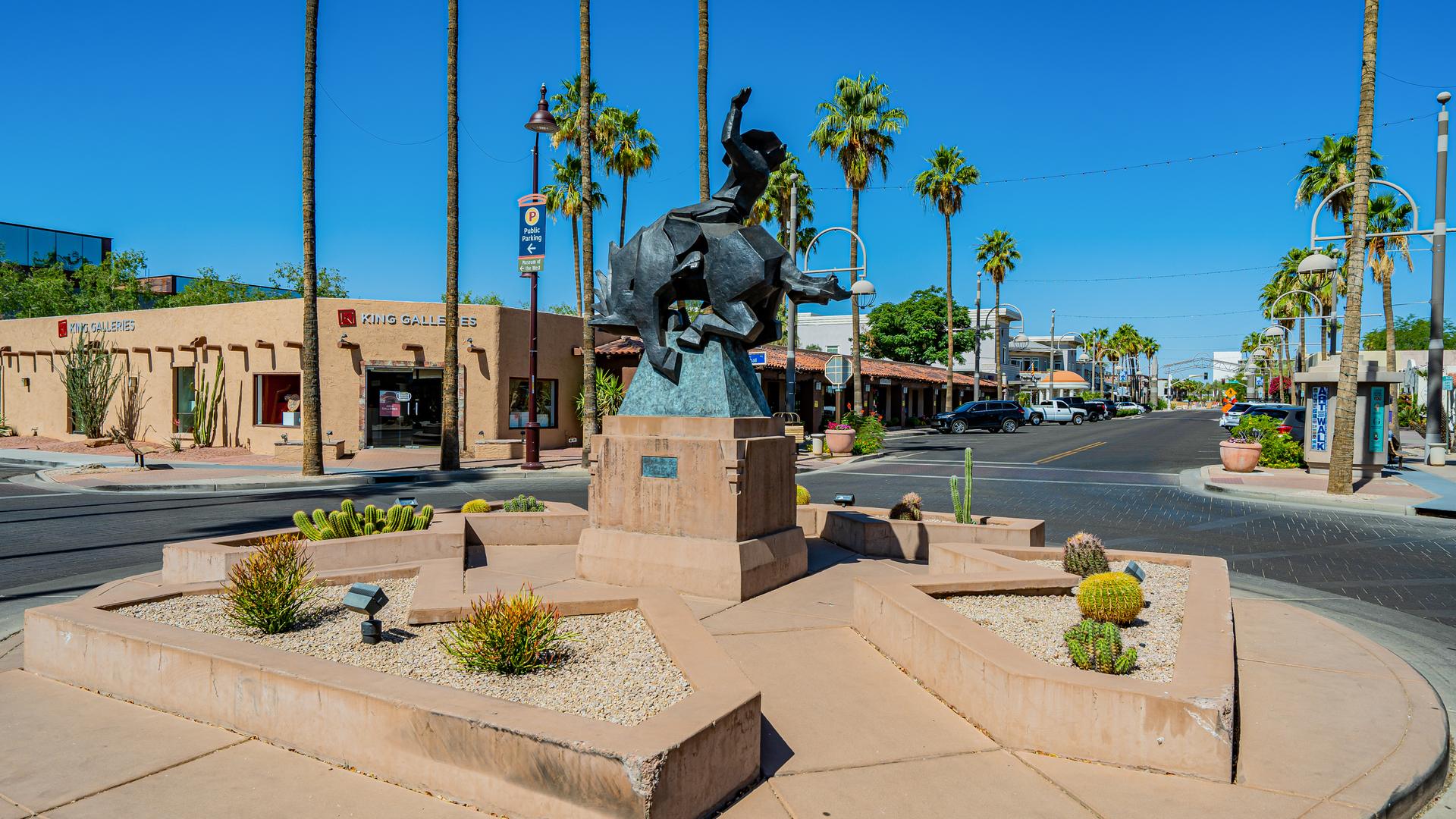 Bronze horse sculpture and palm-lined street in Old Town Scottsdale
