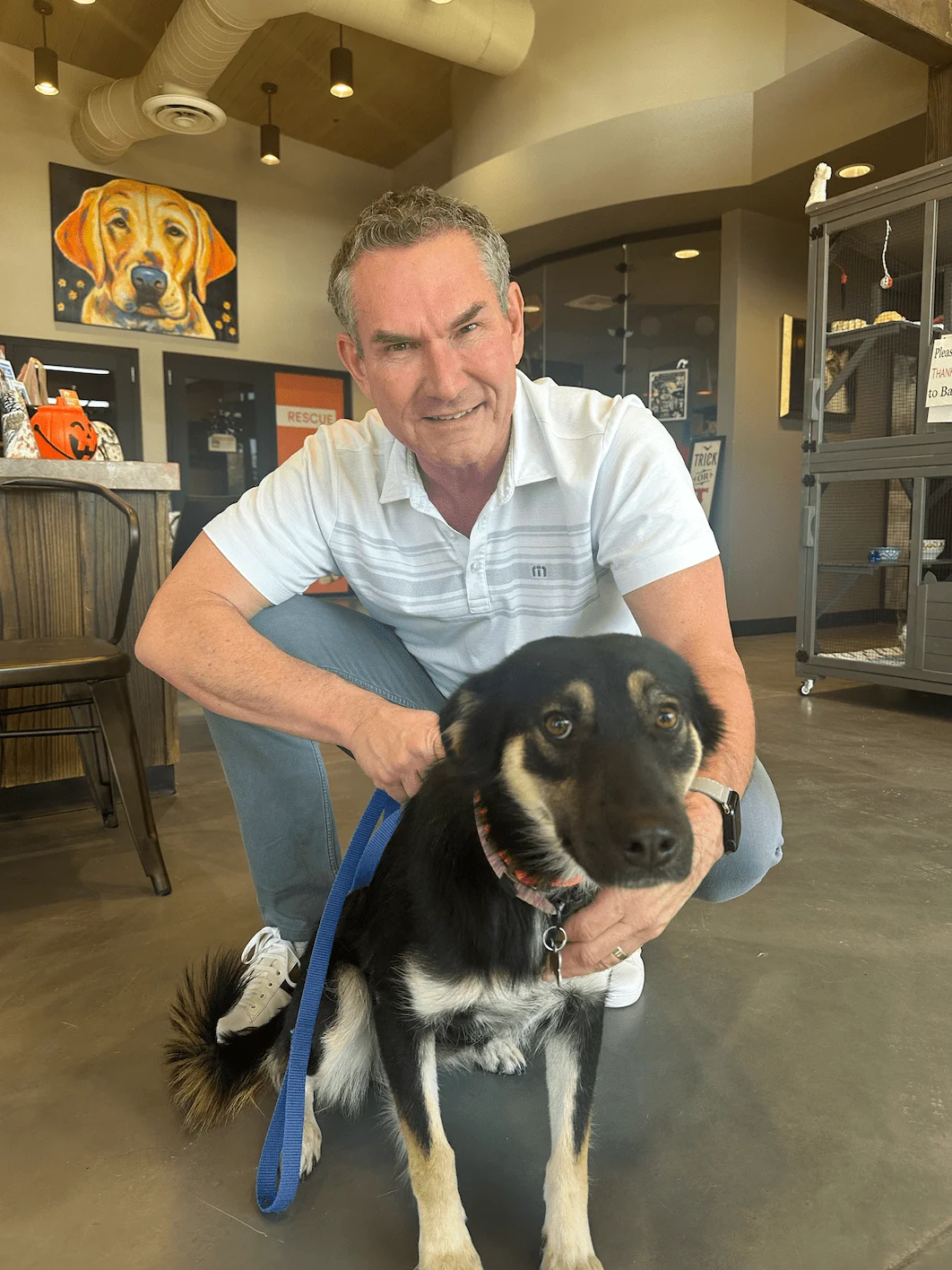 Darren Tackett holding a rescue dog at Foothills Animal Rescue