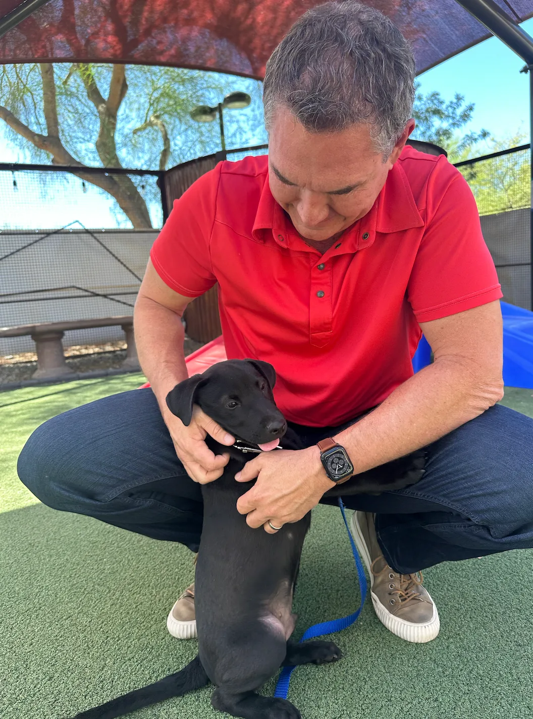 Darren Tackett with a rescue puppy at Foster Friday