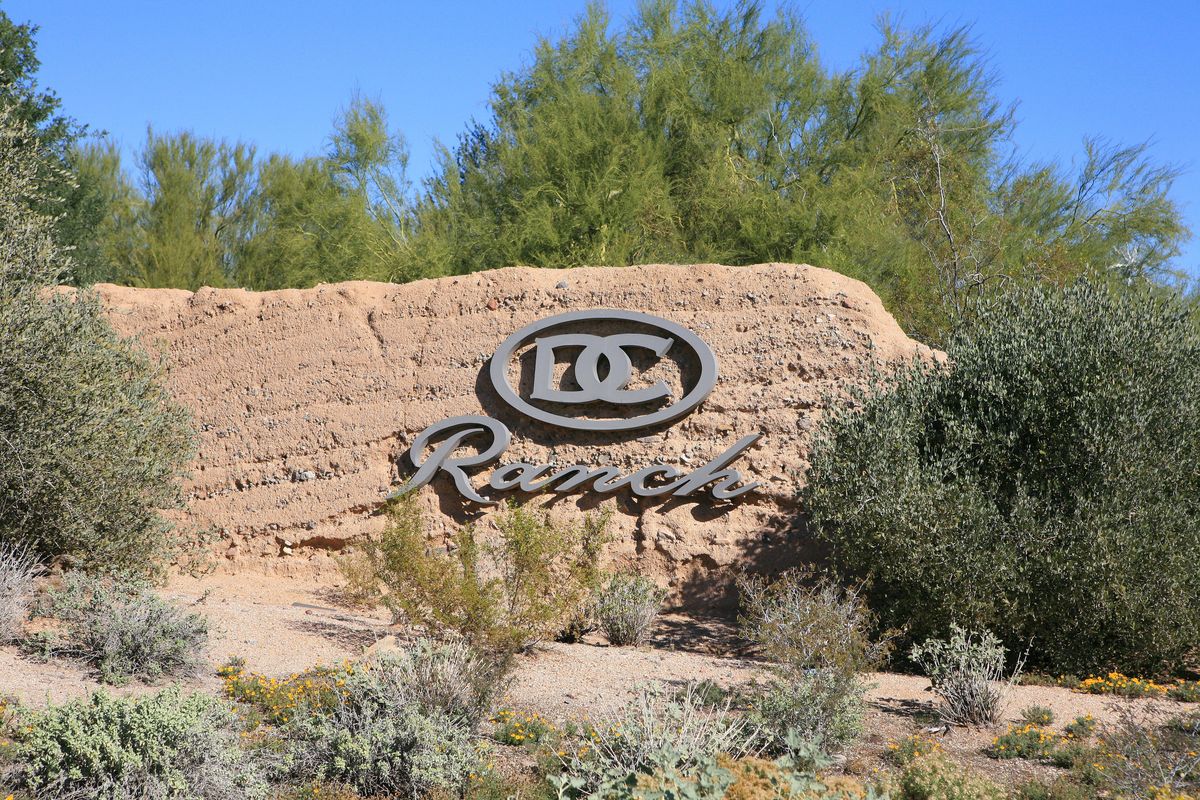 DC Ranch stone entrance monument with desert landscaping in Scottsdale