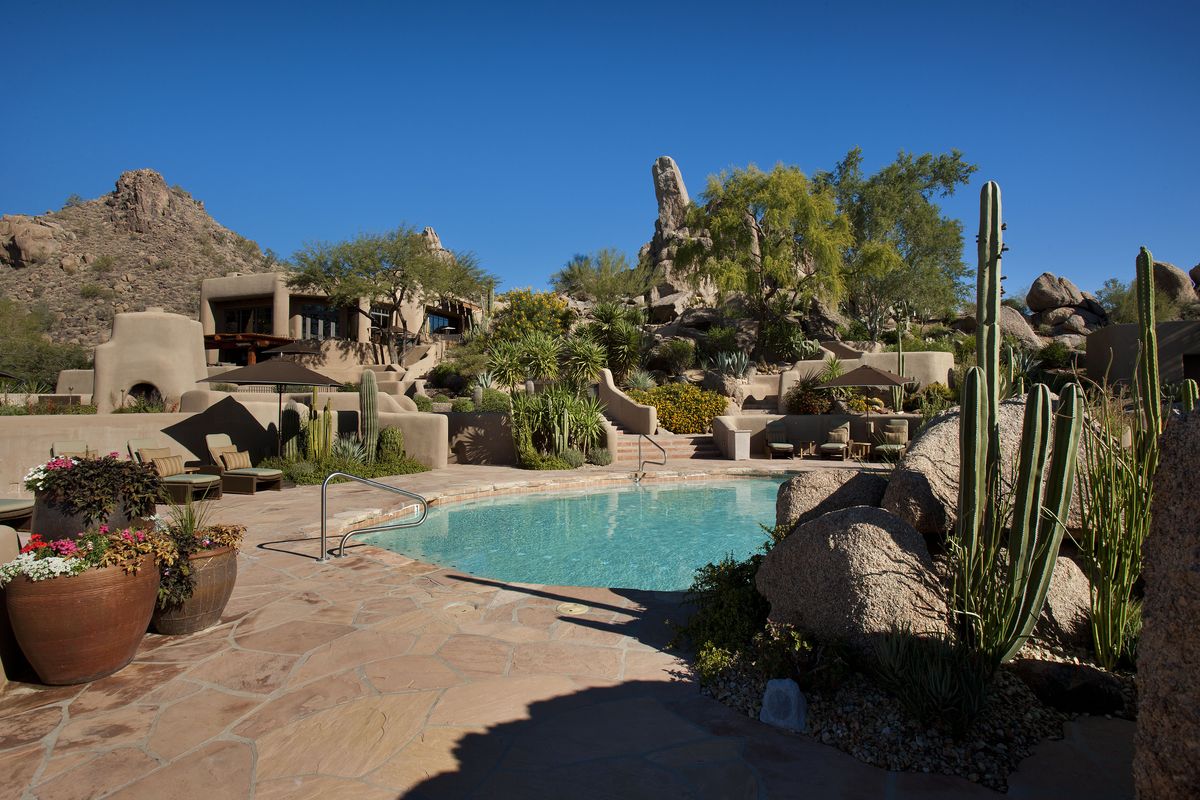 Resort-style pool surrounded by desert landscaping at Desert Highlands, Scottsdale