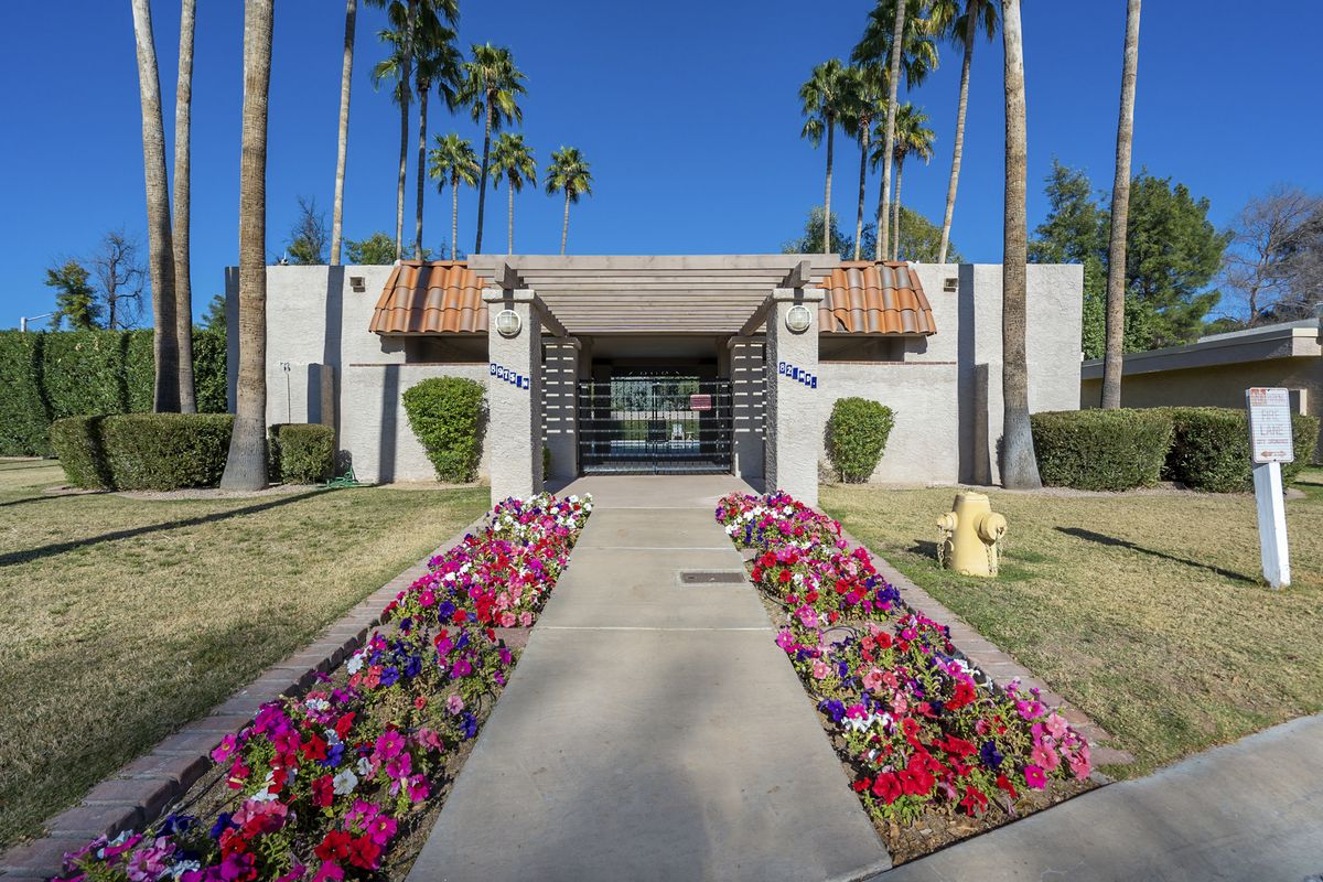 Landscaped community entrance with flower beds in McCormick Ranch, Scottsdale