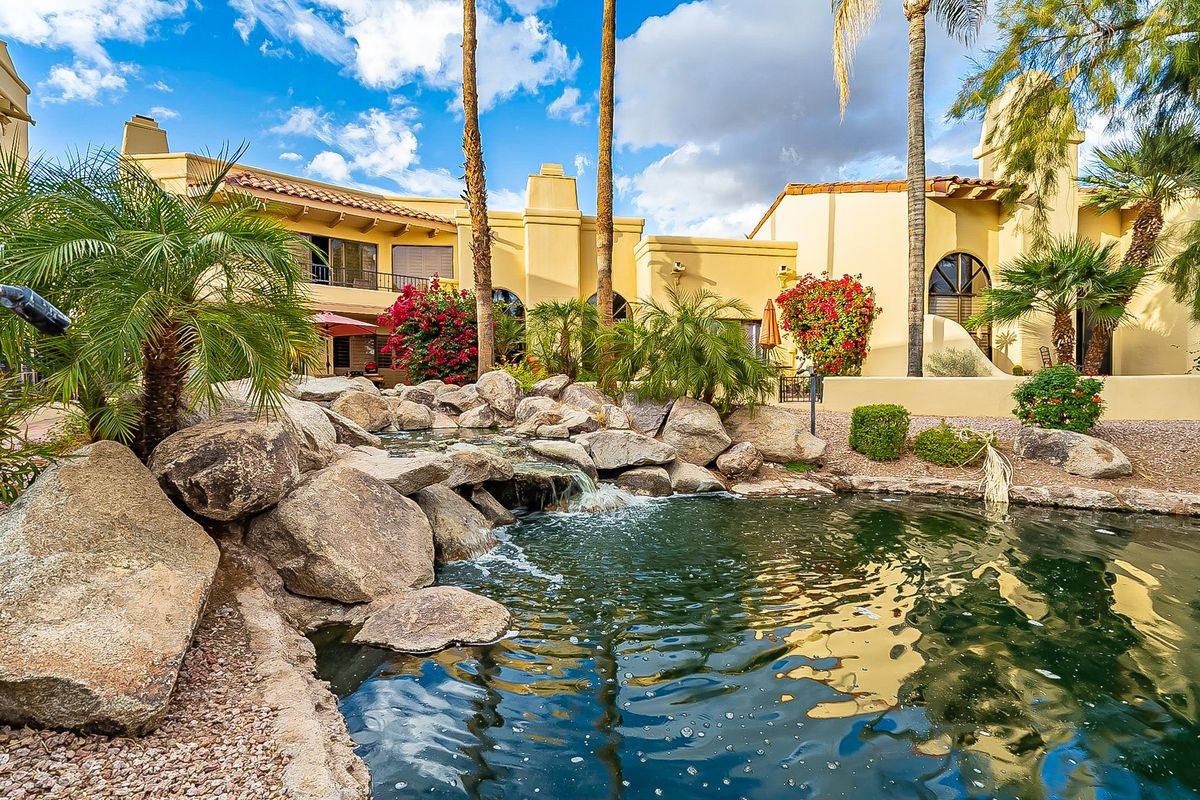 Rock waterfall and palms beside the lake in Scottsdale Ranch, Scottsdale