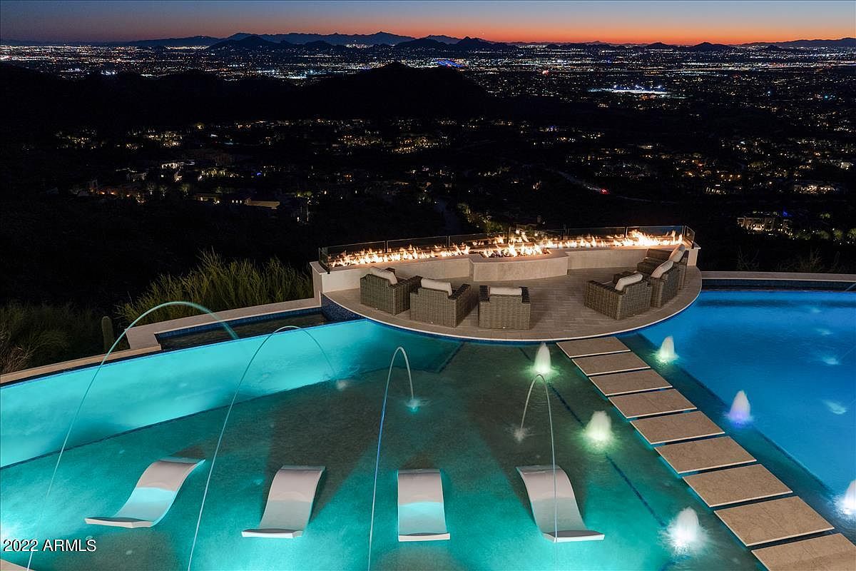 Illuminated pool and fire feature at Altitude at Silverleaf at night